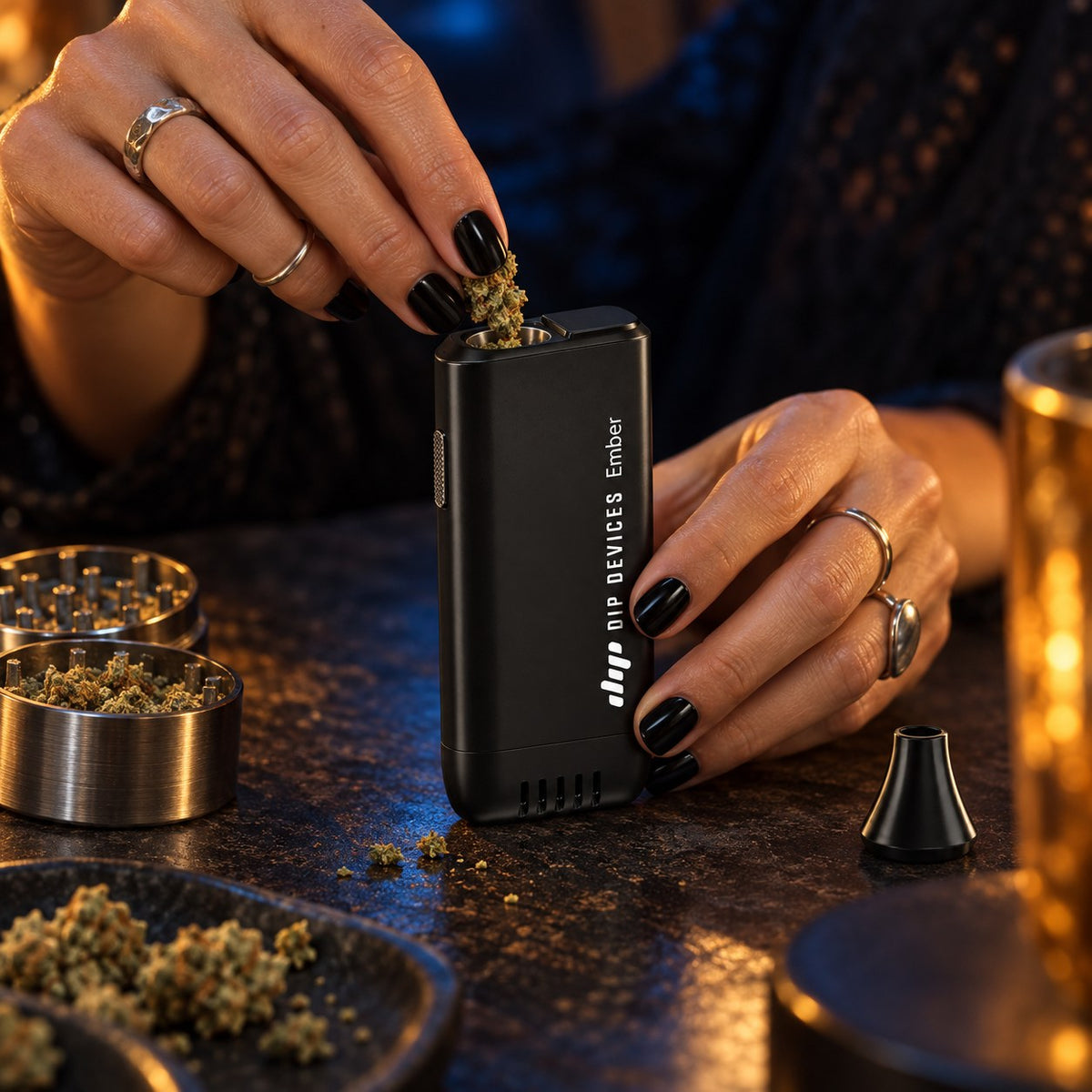 Loading the Ember electric pipe bowl with ground dry herb from a grinder — no lighter or butane required